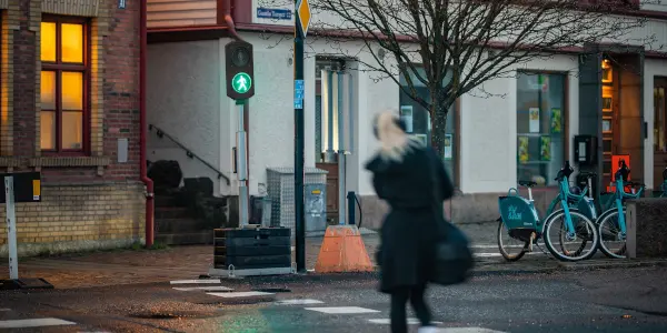Pedestrian traffic signal showing pedestrian crossing to green walking man.