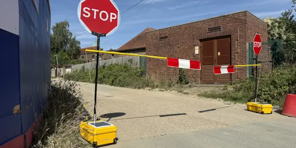 solar powered stop/go with flagger arm barrier attached.