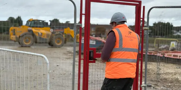 Construction worker using SOSEC side gate to enter site.