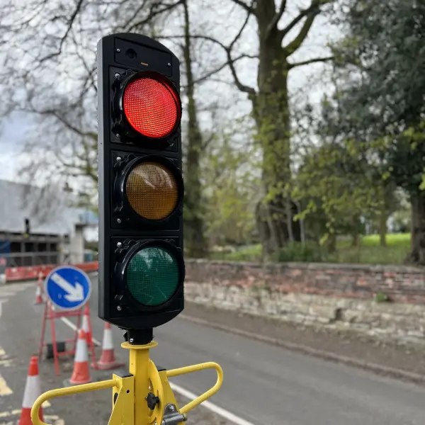 Traffic signal head showing red on road networks.